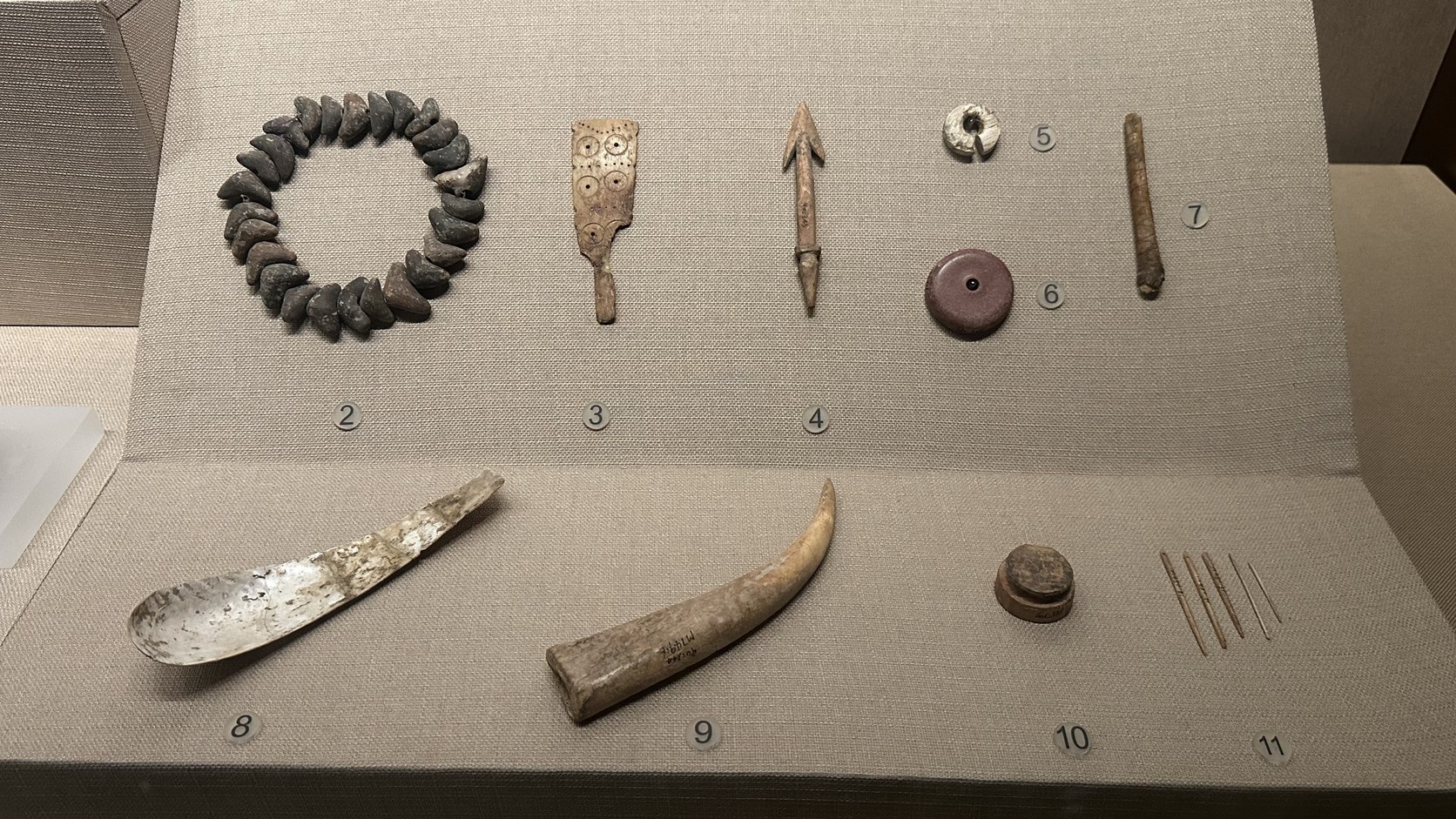 金壇三星村遺址出土的陶串飾、刻紋骨版、骨質梭鏢與蚌勺等展品