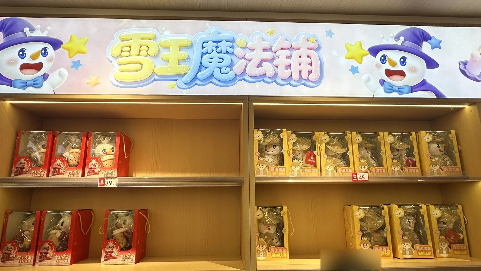 雪王魔法鋪的毛絨玩偶貨架，雪王在手毛絨玩偶 39 元、春遊雪王毛絨玩偶 45 元（右下角人物已模糊）