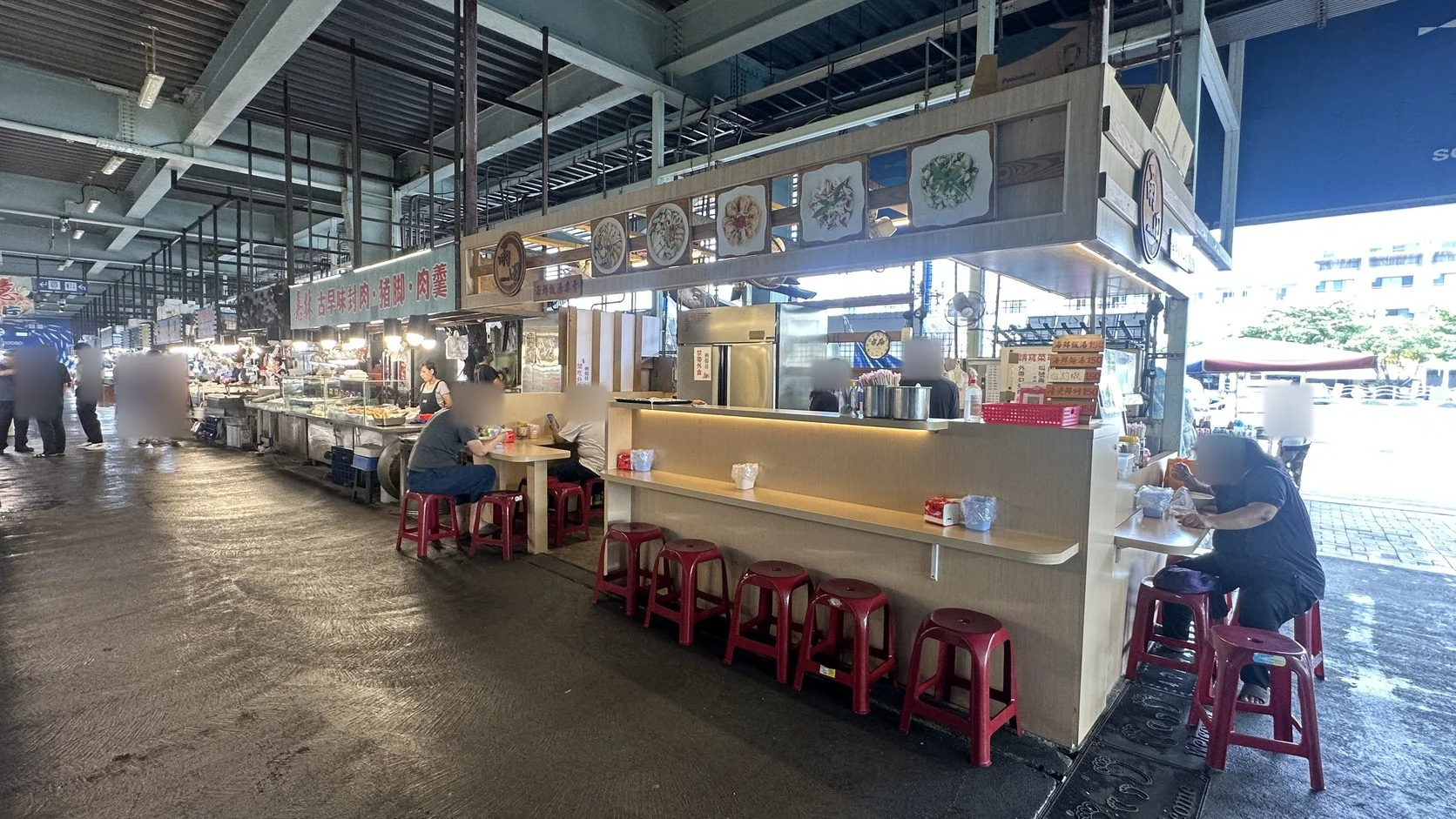 熟食攤位前的吧台式用餐座位與用餐客人